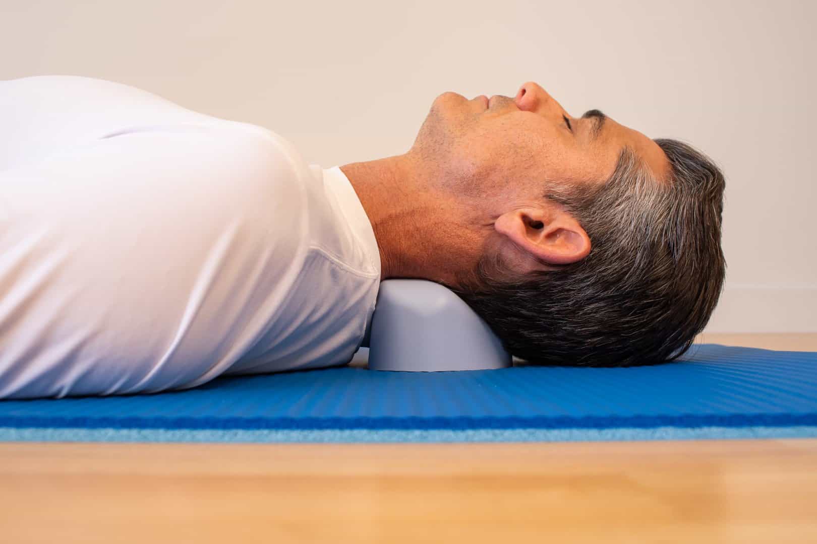 Man Demonstrating using the Sport Craniocradle under the neck